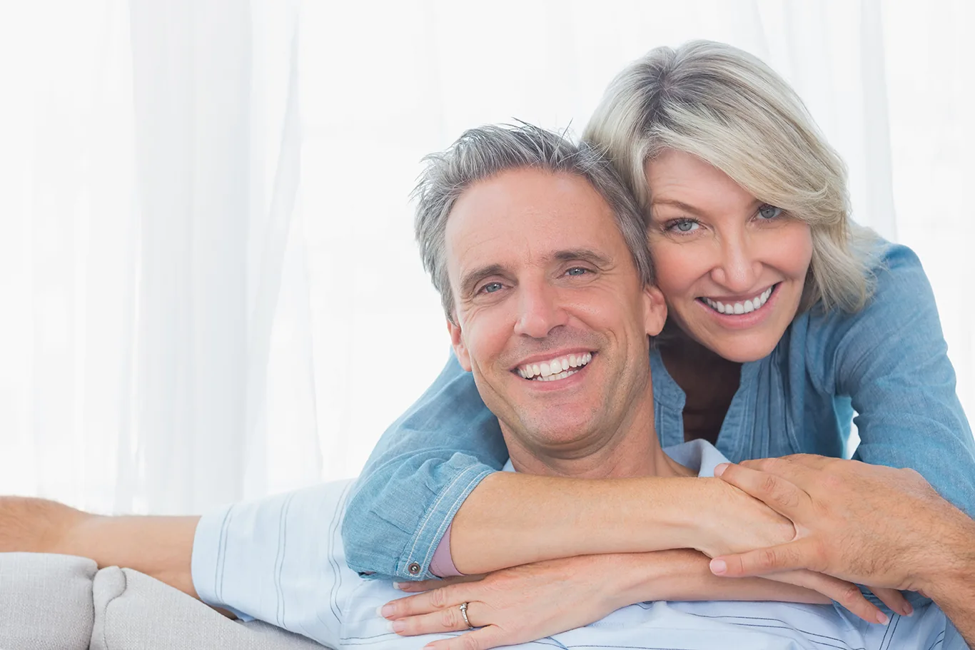 Couple with silver hair relaxing at home